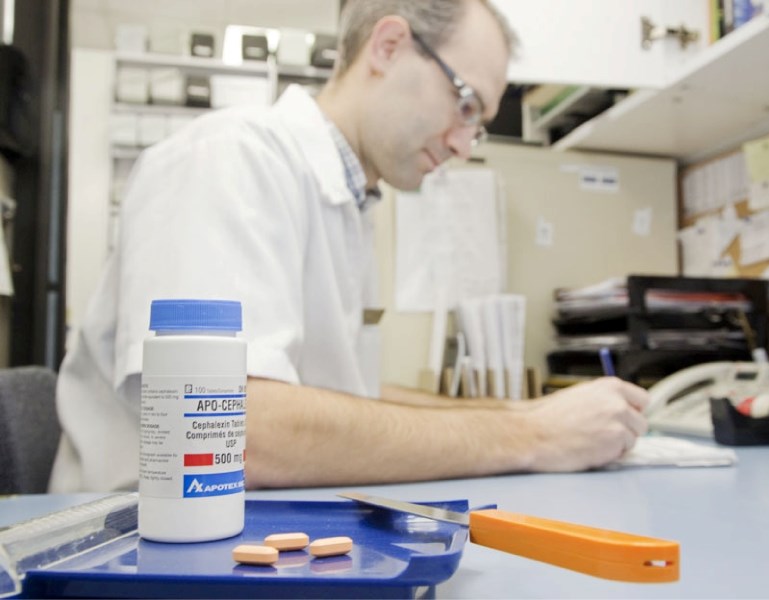 Pharmacist Ryan Diprose fills out a perscription at the Grandin Prescription Centre. Diprose is one of many pharmacists in Alberta who have been affected by a recent shortage 