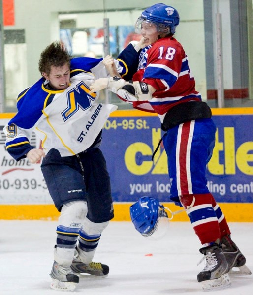 Nicolas Addessi of the St. Albert Merchants and Russell Turner of the Morinville Jets trade punches during Sunday&#8217;s junior B dustup at Ray McDonald Sports Centre. The
