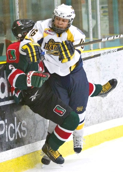 Michael Buchamer of the St. Albert Sabres nails Erik Donald into the boards in Wednesday&#8217;s bantam AAA game against the SSAC Southgate Lions at Akinsdale Arena. The