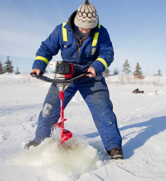 Brandon Benson uses an auger to fashion a hole in the ice at the Morinville Fish &amp;amp; Game Pond