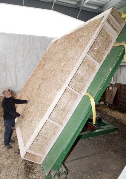 Peter Zuurdeeg of Go Green Ltd. surveys a 12&#8242;-by-14&#8242; straw bale panel under construction at his Onoway facility. The wall