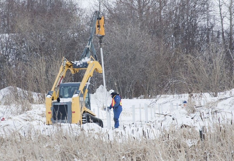 Workers begin installing the supports for a boardwalk at the future John E. Poole Interpretive Wetland near Big Lake. The new platforms and walkways are scheduled to be open