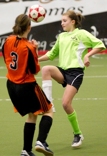 Morgan Wilson (green) of the St. Albert Serpents works to control the ball against the Calgary MSB United Panthers in Saturday&#8217;s U14 group B match at the second annual