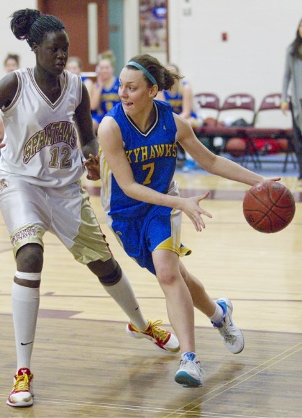 Hayley Warmington of the St. Albert Skyhawks drives around Adut Bulgak of the O&#8217;Leary Spartans during Wednesday&#8217;s first-place showdown in metro Edmonton premier