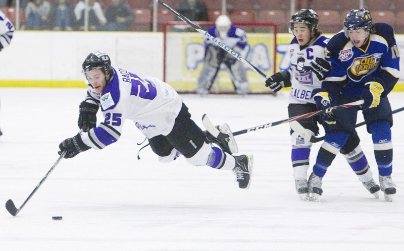 Derek Bacon of the St. Albert Steel is upended during second-period action in Monday&#8217;s 13-2 rout by the Fort McMurray Oil Barons at Performance Arena. The Oil Barons