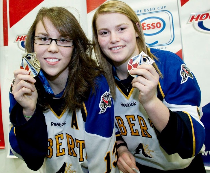 St. Albert Slash forwards Melissa Kueber (left) and Jessica Kampjes with the U18 provincial team show off their gold medals from the Canada Winter Games. Alberta edged