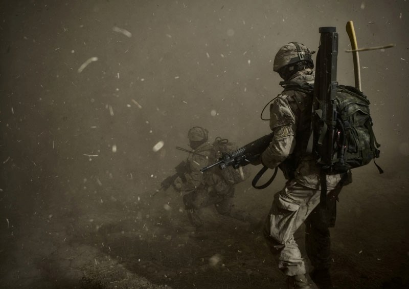 Canadian soldiers walk through a huge dust cloud as they prepare to board a helicopter in Afghanistan. Helicopters are often used by soldiers to reach remote locations and