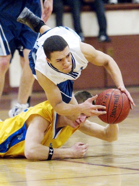 Brandon Best of the Paul Kane Blues is tripped up after stealing the ball against the Bev Facey Falcons in the first half of the metro Edmonton premier men&#8217;s final