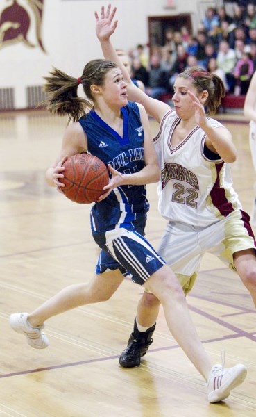 Sarah Thomas of the Paul Kane Blues drives to the net against Cheyenne Pyrozko of the O&#8217;Leary Spartans in the metro Edmonton premier women&#8217;s final Saturday at