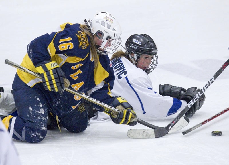 Krystal Reithmayer of the St. Albert Slash and Stephanie Zvonkovic of the Edmonton Thunder muck it up for the puck during Sunday&#8217;s spirited playoff affair at