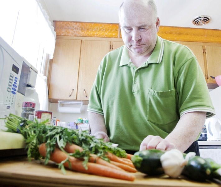 Jim Starko prepares a healthy meal in his home in the Grandin area of St. Albert. Starko is involved in a unique program called the Obesity Awareness and Control Initiative