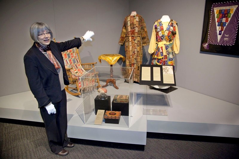 Western Canadian history curator Cathy Roy shows off some of the fabric novelties made from small silk patches that could be found in tobacco products from 1880 to 1920. The