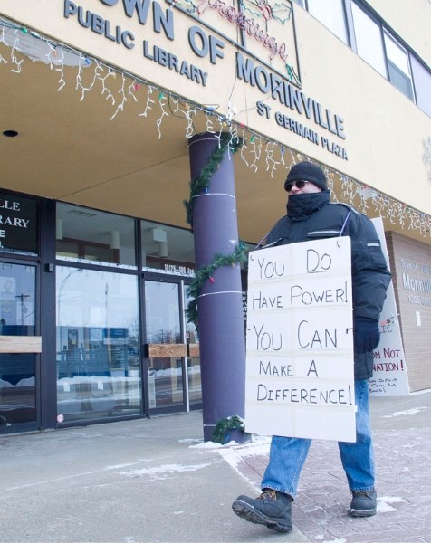 Thomas Kirsop pickets in front of the Town of Morinville office on Friday after the town opted not to wade into a debate over secular education. Education Minister Dave
