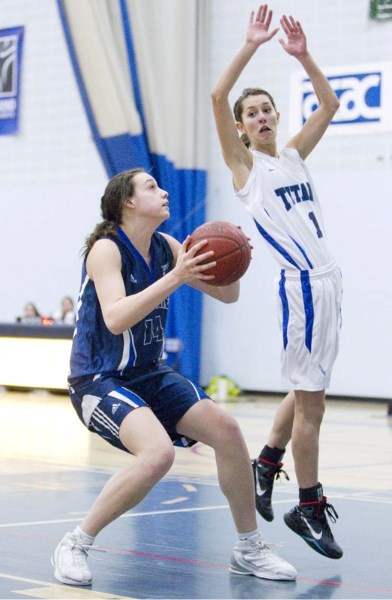 Whitney Follette of the Paul Kane Blues fakes a shot against Jessie Olsen of Harry Ainlay Titans during Saturday&#8217;s 4A Edmonton zone playoff at The King&#8217;s