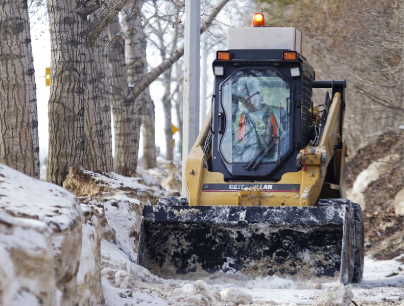 City crews are working to clear snow and ice along city sidewalks to minimize the damage caused by the constant melting and freezing of ice and water that can damage concrete 