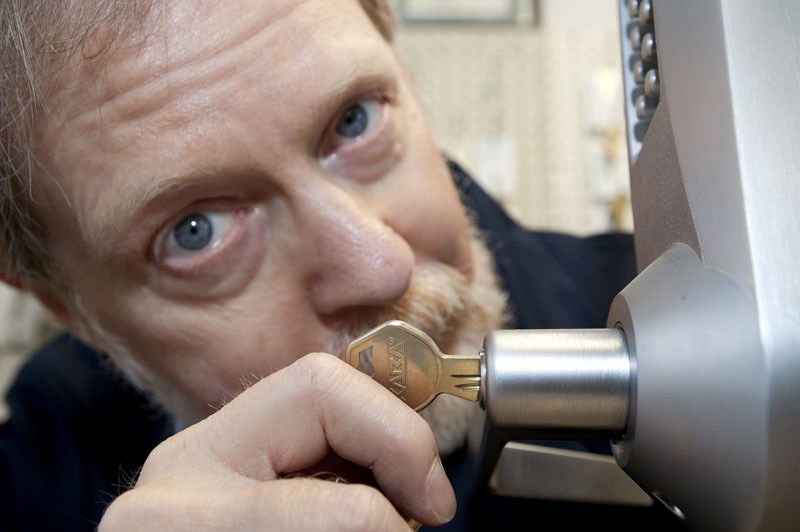 Phil Meagher of Celtic Lockworks demonstrates the operation of a keypad lock in his Edmonton shop. Most electronic locks have manual backups in case the power goes out.