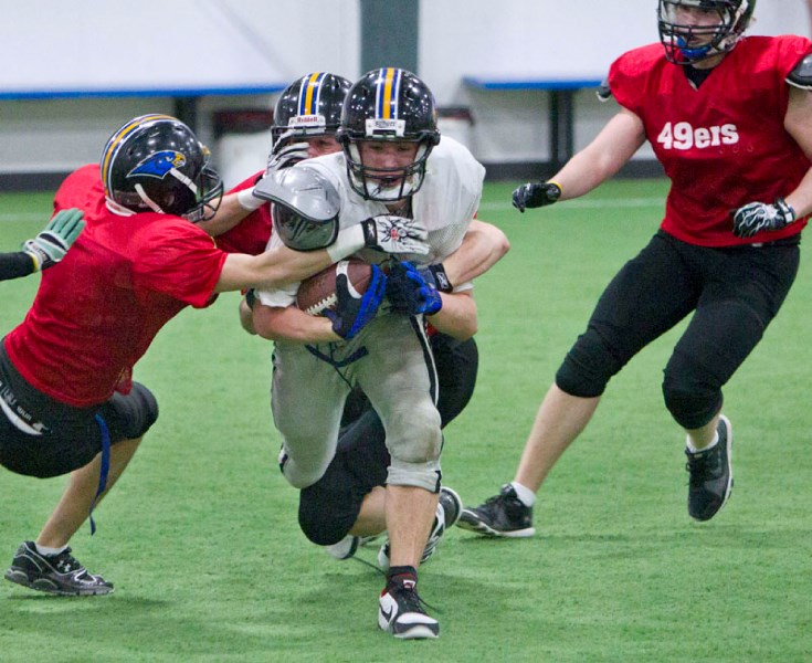 Ball carrier Nathan Pytel is tracked down during a drill at the St. Albert Storm&#8217;s practice Wednesday at the Karl Weidle Indoor Centre. Today