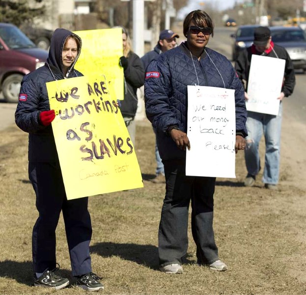 Postal workers picket on Hebert Road on Wednesday afternoon