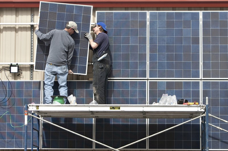 Solar panels are installed by Bill Manning (L) and Benn Kilburn at the new Kingswood Shelter for the St. Albert Nordic Ski Club in Red Willow Park. STANSKI held their grand