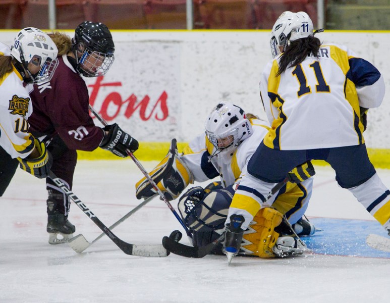 St. Albert Slash netminder Emily Mitchell stops the puck against the MacEwan Griffins in Sunday&#8217;s exhibition at Performance Arena. Providing defensive support is