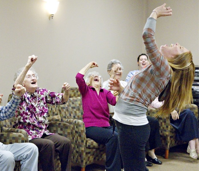 Yoga Laugh leader Nicole van Velzen leads a group of residents at River Ridge Seniors Community in some laugh therapy on Monday afternoon.