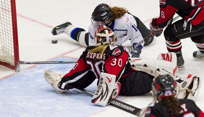 Mikaeli Cavell of the Edmonton Thunder searches for the puck after colliding with Toronto Aeros&#8217; goalie Sarah Stephens during second period action Monday at the Esso