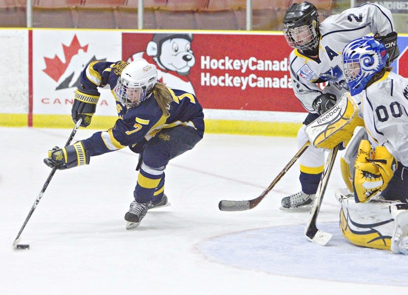 Deanna Morin of the St. Albert Slash prepares to go backhand against Kings County Kings&#8217; goalie Emma Meanor in the second period of Monday&#8217;s Esso Cup game at