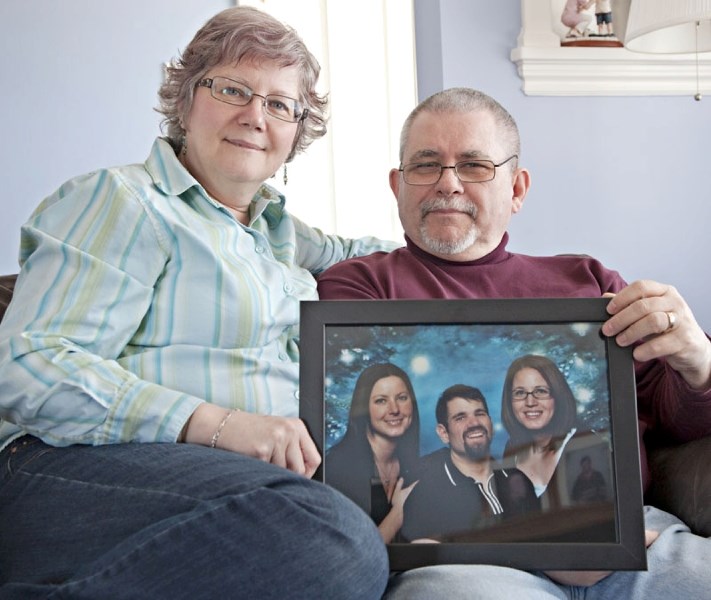 St. Albert residents Jan and Rick Fortier whose son Adam (pictured in the framed photograph) is a liver transplant receiver