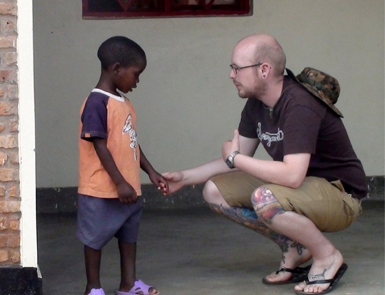 Aaron Brink of Youth Unlimited meets a young Burundian during a mission trip last year. Brink is organizing a return trip this year.