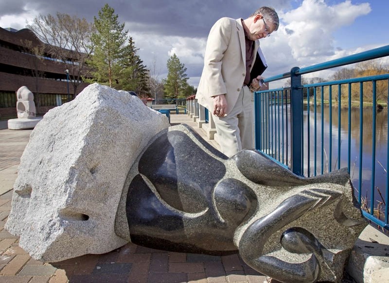 A disappointed Mayor Nolan Crouse surveys the damage to a granite sculpture created by aboriginal artist Stewart Steinhauer after it was vandalized sometime over the weekend. 