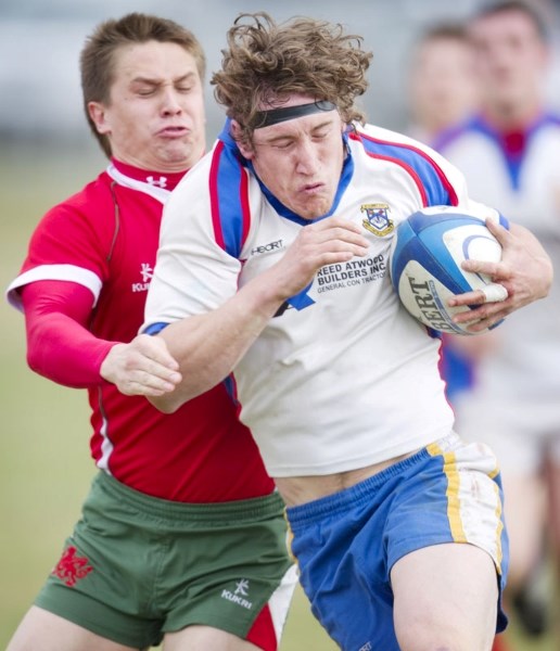 Ben Robinson of St. Albert is tracked down by a Druids&#8217; defender in the Alberta Cup season-opener Saturday at Ellerslie Rugby Park. The Druids upset the defending