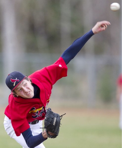 Marcus Blair of the St. Albert Cardinals guns the ball against the Strathmore Reds in the first game of Saturday&#8217;s midget AAA doubleheader at Legion Memorial Park. The
