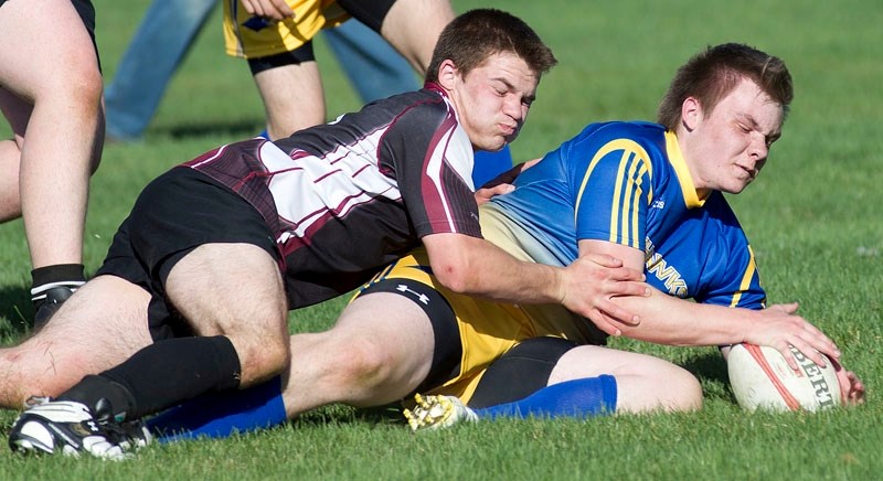 Nathan Gies of the St. Albert Skyhawks is pinned to the ground by Kieran Fraser of the Bellerose Bulldogs in Wednesday&#8217;s high school rugby match at the St. Albert Rugby 