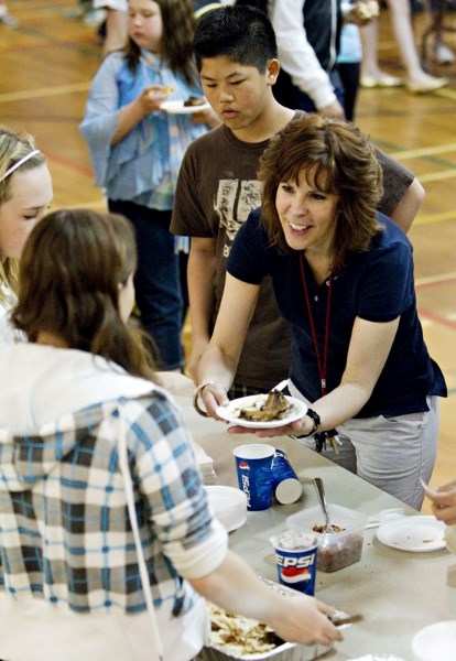 Lorne Akins principal Loretta Manning gets herself some lunch during the Taste of Akins fundraiser at the school. Students and staff sampled food from many different cultures 