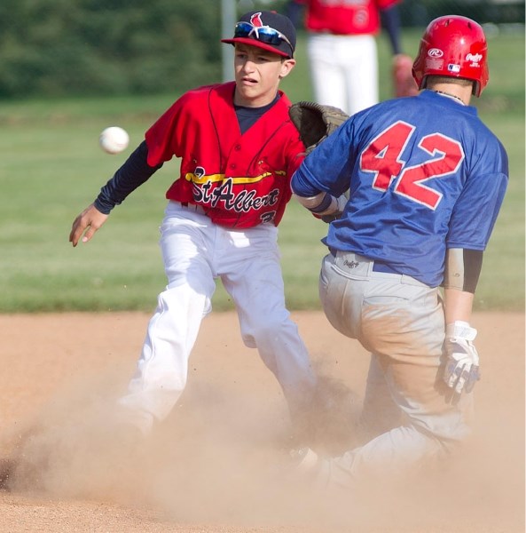 Red Deer Braves runner Riley Guntrip is safe at second after the bantam AAA St. Albert Cardinals fail to throw him out at second during St. Albert Early Bird Tournament play