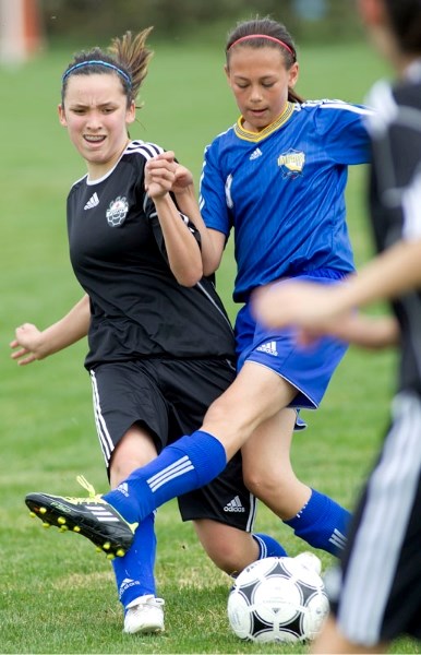 Louise Logan of the St. Albert Impact U14 makes her way past one of the Fort McMurray players during tournament play for the Victoria Day Classic girls tourney last Saturday