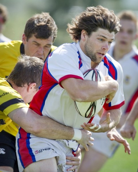 Adam Bontus of St. Albert is wrapped up while plowing forward with the ball in Saturday&#8217;s 27-14 loss to the Calgary Hornets at the Leading Edge Physiotherapy Fields.