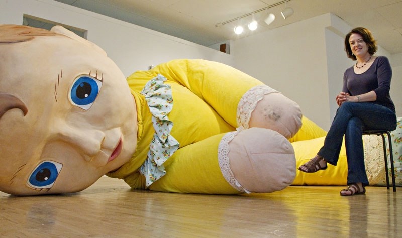 Art Gallery of St. Albert director Frances Gagnon takes a seat beside Field Doll