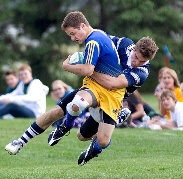 Josh Grasser of the Paul Kane Blues takes down Stephen Cain of the St. Albert Skyhawks in the metro Edmonton city conference final Wednesday at the St. Albert Rugby Football