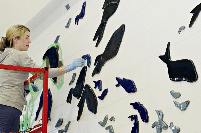 Edmonton artist Claire Uhlick works on her mural entitled Through the Tides
