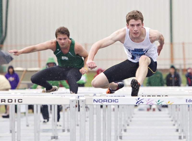 Garrett King (right) of the Paul Kane Blues led the way in the senior boys&#8217; 100-metre hurdles at the Alberta Schools&#8217; Athletic Association championships on a