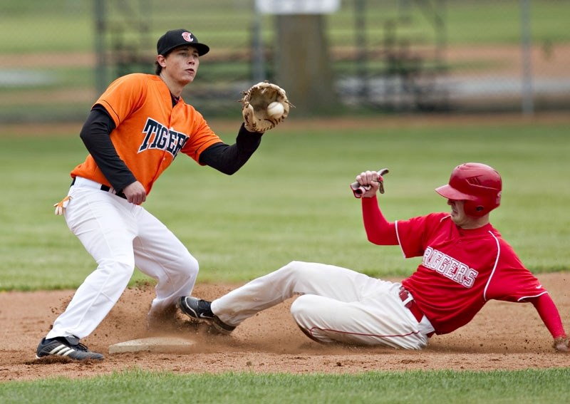 St. Albert Tigers Orange second baseman Dan Wiun starts a double play against the Red Deer Riggers in Saturday&#8217;s doubleheader in the Sunburst Baseball League. The