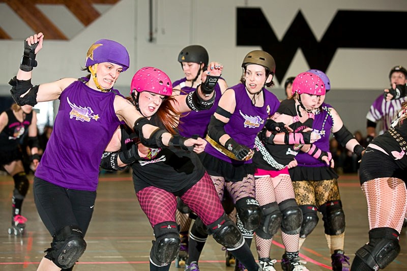 The St. Albert Heavenly Rollers (purple) and the Missfits of Mayhem jostle for positioning during a bout in April. Next Saturday the Heavenly Rollers host Lethbridge&#8217;s