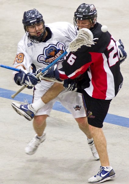 Steve Skoreyko (L) of the Edmonton Outlaws and Steve Zwack of the St. Albert Miners collide while battling for the ball in Wednesday&#8217;s senior B tilt in the Rocky