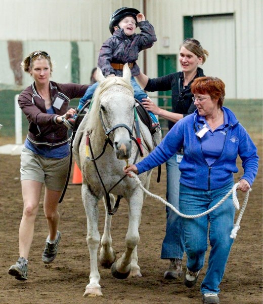 Four-year-old Graden Nemeth got the ride of his life Saturday as volunteers (L-R) Crystal Bruce