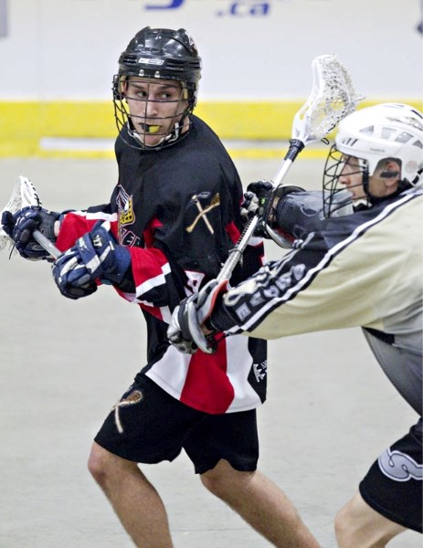 Shane Lopatynski of the St. Albert Miners eyes up a passing play while pressured by a Spruce Grove Slash player in Wednesday&#8217;s senior B match in the Rocky Mountain