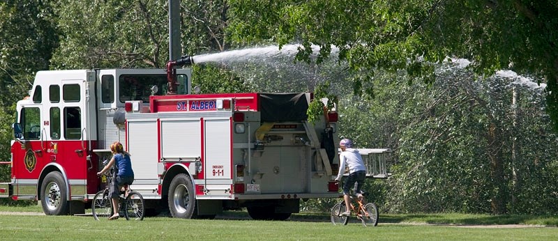 Fiurefighters extinguish a nuisance fire behind Robert Rundle School on Thursday morning