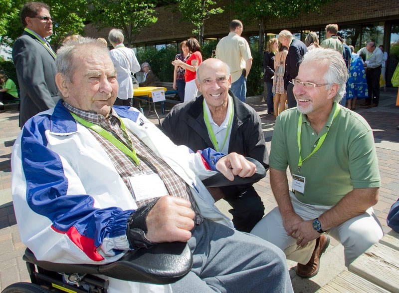City manager Bill Holtby (right) talks with former City of St. Albert staff members Frank Ricard and Marcel Dechamplain (middle) during a St. Albert staff reunion last