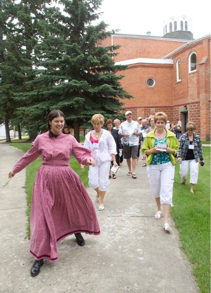 Christina Williamson guides a group during a stop at the St. Albert Catholic Parish