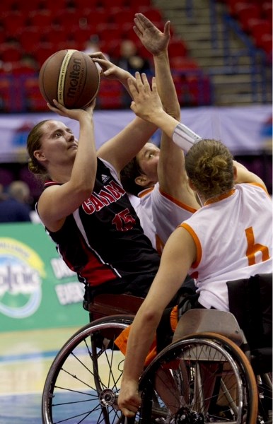 Tara Feser of St. Albert eyes up a shot against double coverage for Canada against The Netherlands at the 2010 World Wheelchair Basketball Championships in Birmingham